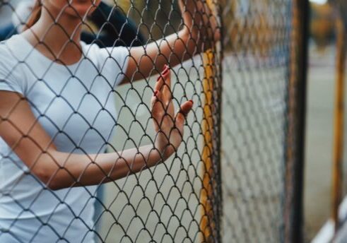 woman-standing-near-fence